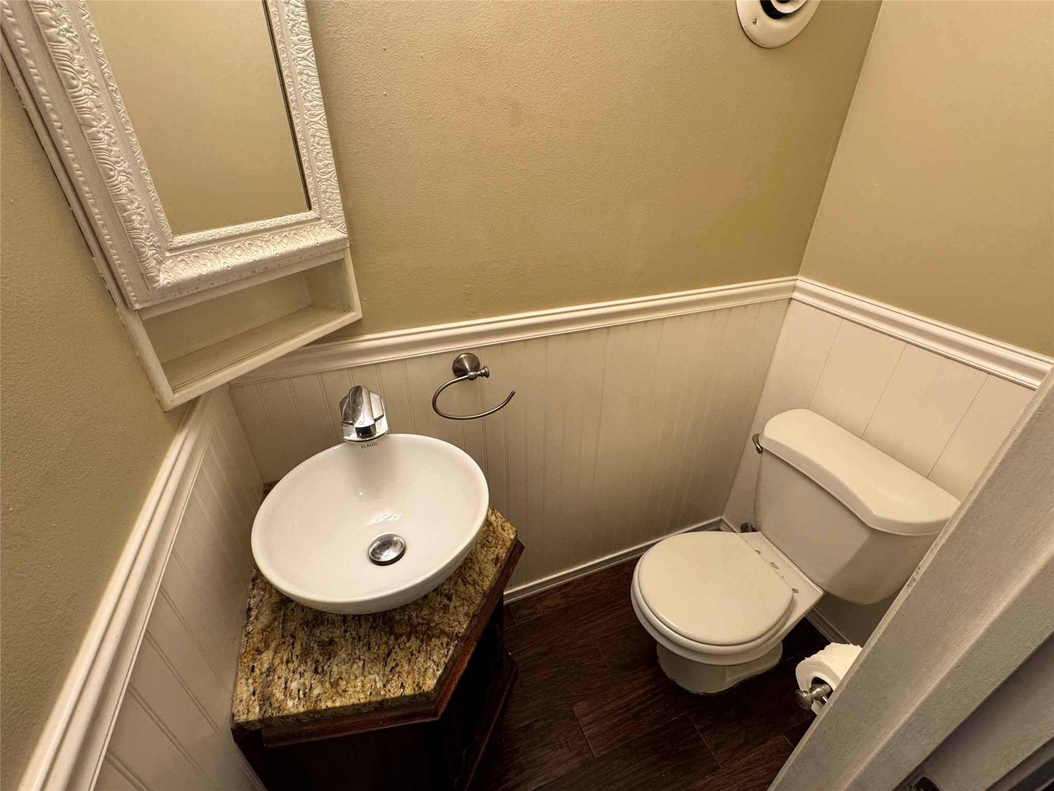 2041 Winrock Boulevard, Unit 157 Houston, TX 77057 - Photo 7 of 26 a bathroom with a toilet a sink and a mirror