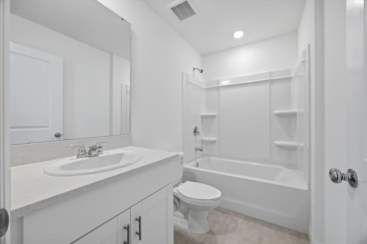 2907 Skyline Loop Kissimmee, FL 34758 - Photo 11 of 12 a bathroom with a sink a toilet and shower