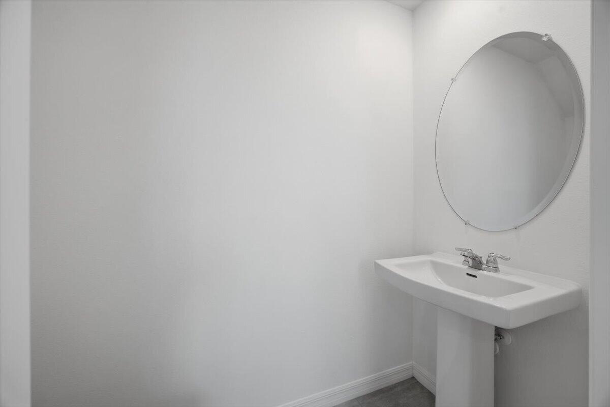 2907 Skyline Loop Kissimmee, FL 34758 - Photo 4 of 12 a bathroom with a sink and a mirror