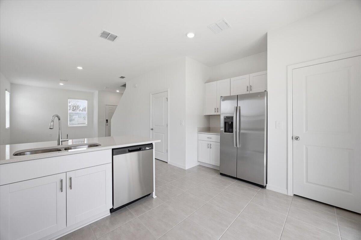 2907 Skyline Loop Kissimmee, FL 34758 - Photo 6 of 12 a kitchen with a sink and refrigerator