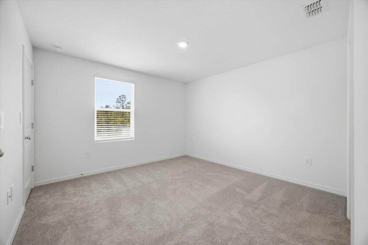 2907 Skyline Loop Kissimmee, FL 34758 - Photo 7 of 12 an empty room with a window