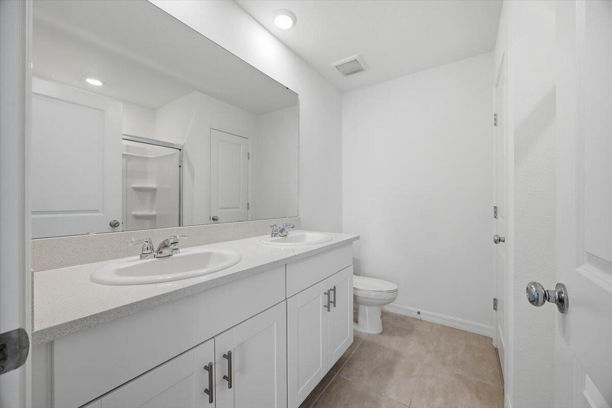 2907 Skyline Loop Kissimmee, FL 34758 - Photo 8 of 12 a bathroom with a sink and a mirror