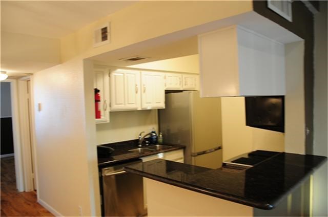 6001 Reims Road, Unit 1202 Houston, TX 77036 - Photo 10 of 16 a kitchen with a sink appliances and cabinets