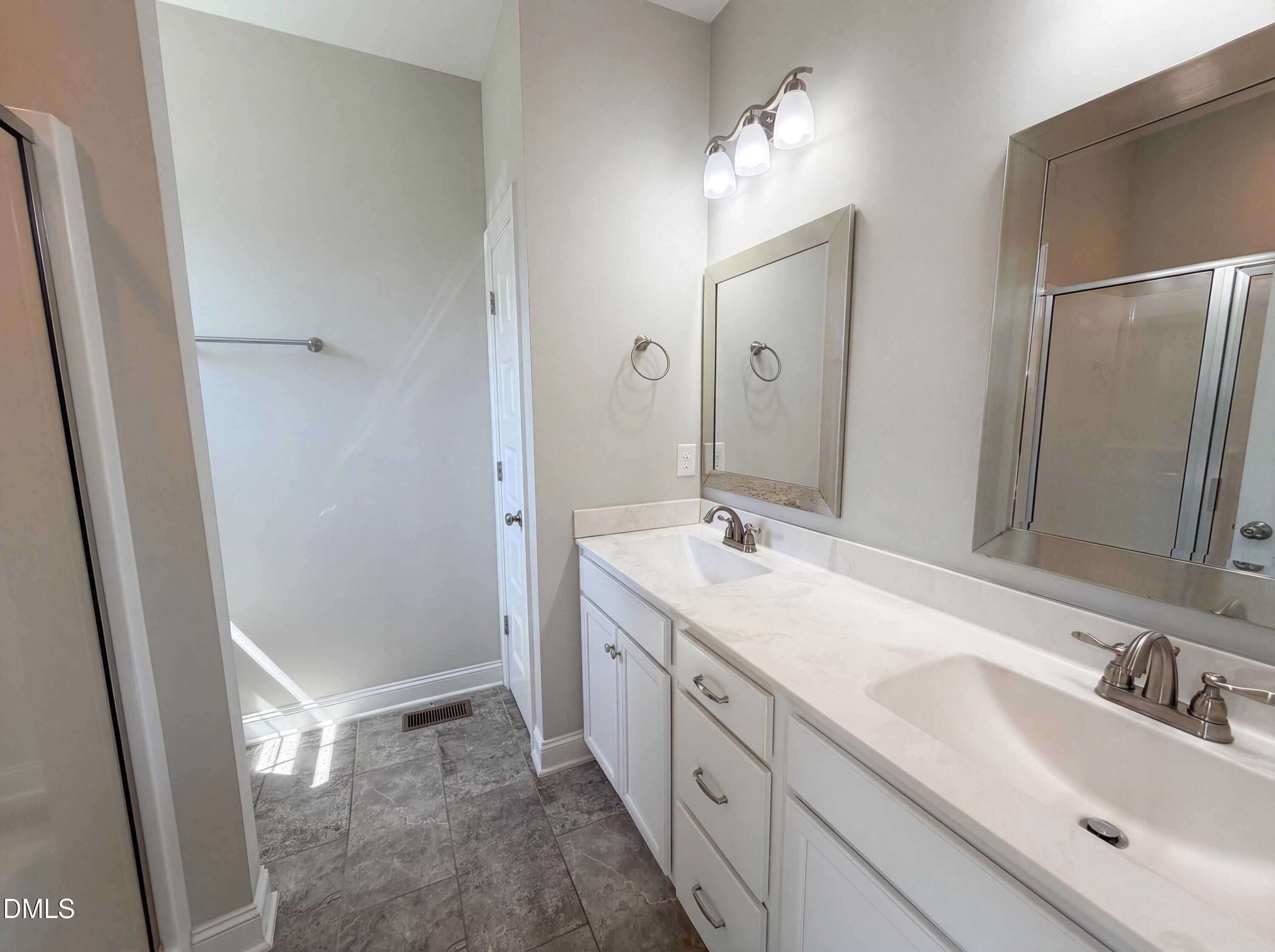 987 Red Stone Court Rougemont, NC 27572 - Photo 13 of 14 a bathroom with a double vanity sink mirror and double