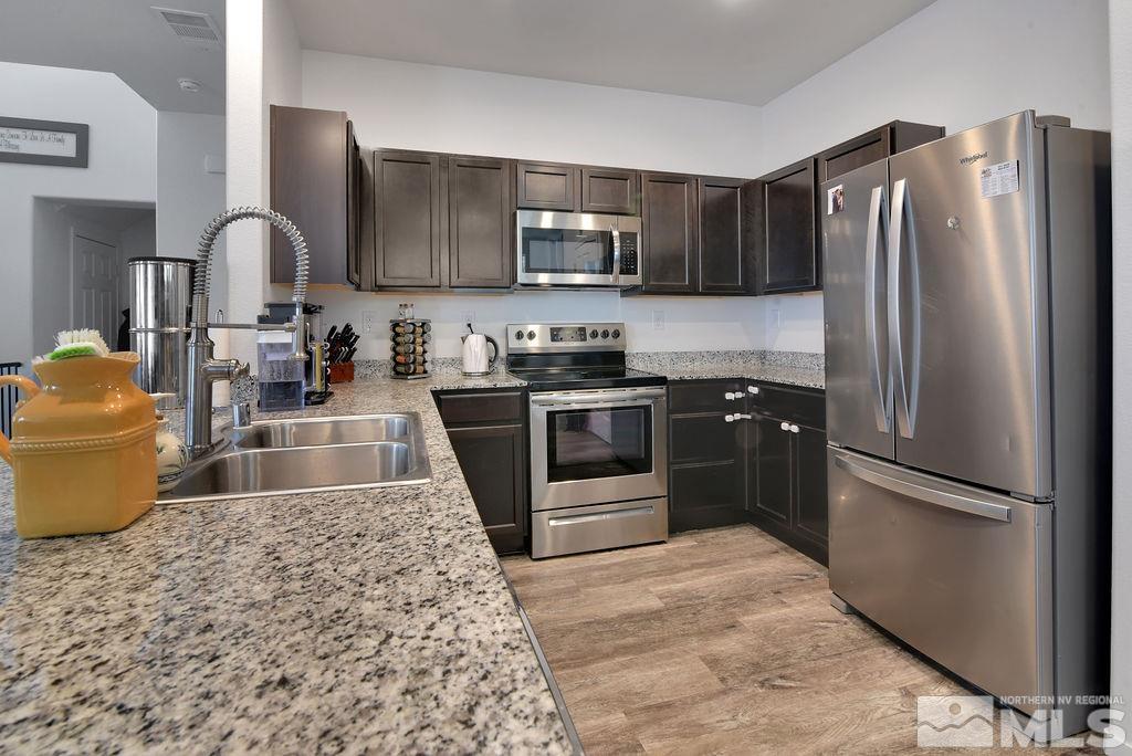 9622 Windjammer Way Reno, NV 89506 - Photo 20 of 29 a kitchen with stainless steel appliances granite countertop a refrigerator stove and sink