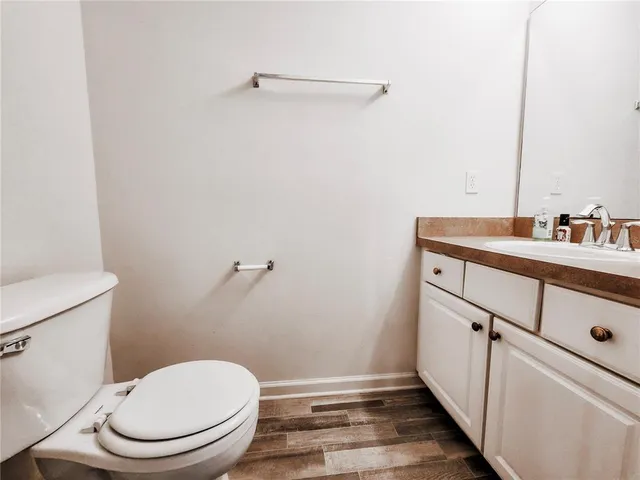 a bathroom with a toilet a sink and mirror