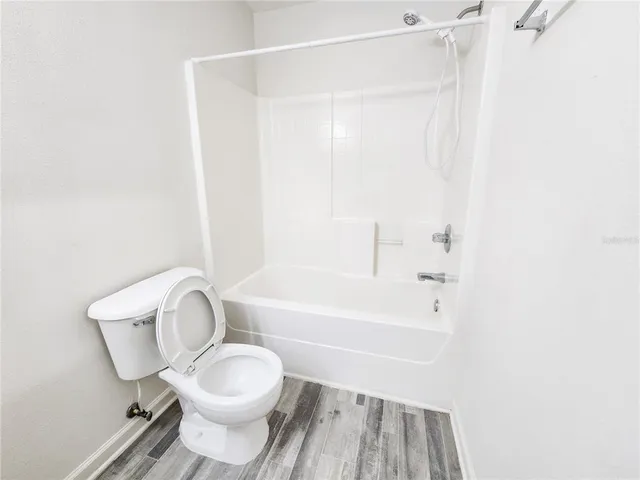 a bathroom with a toilet and a bathtub