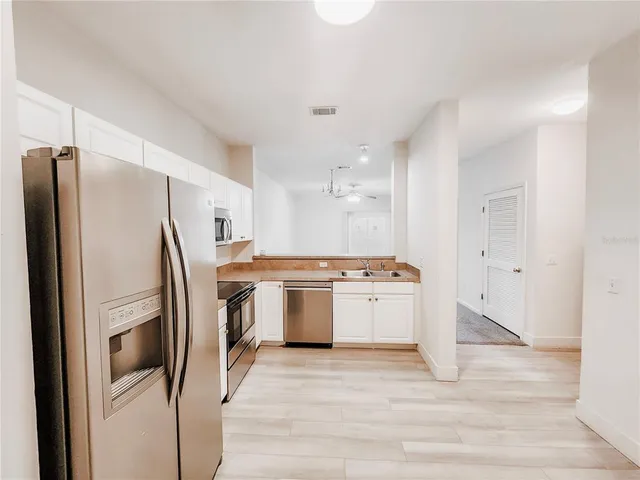 a kitchen with stainless steel appliances a refrigerator stove and sink