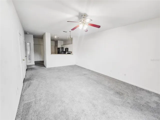 a view of a livingroom with a ceiling fan and window
