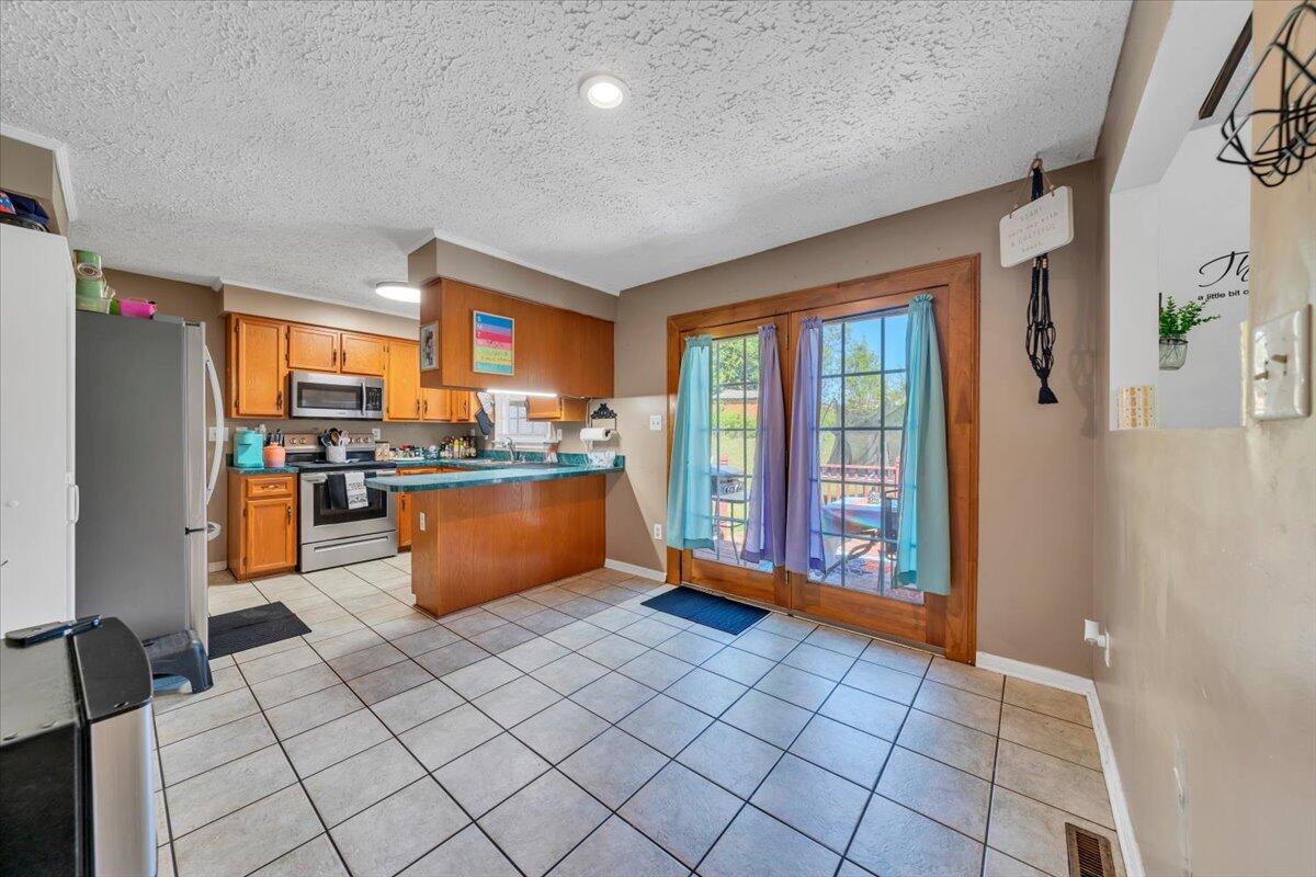3870 Goose Dam Road Rocky Mount, VA 24151 - Photo 11 of 44 a kitchen with stainless steel appliances granite countertop a refrigerator and a sink