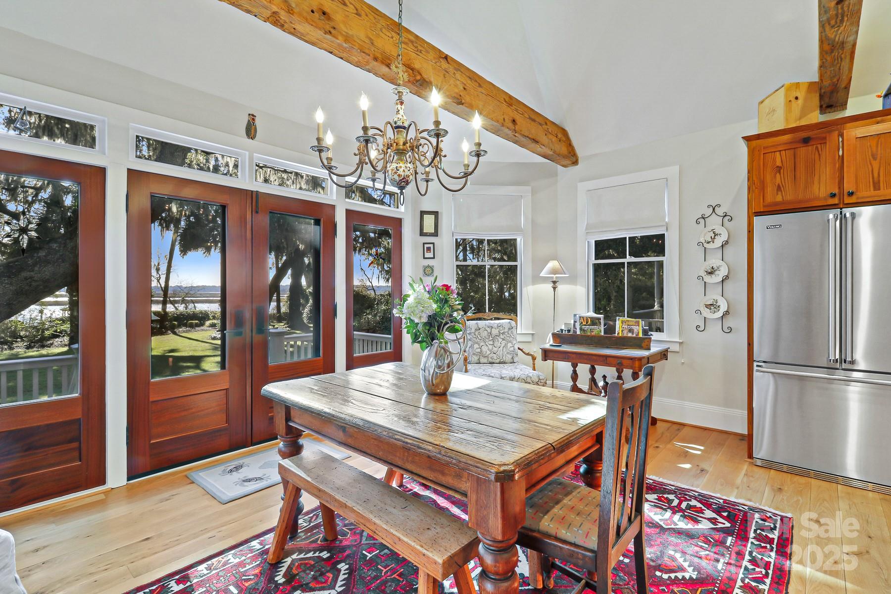 131 Pritchard Street Bluffton, SC 29910 - Photo 14 of 47 a dining room with furniture a kitchen view and a chandelier