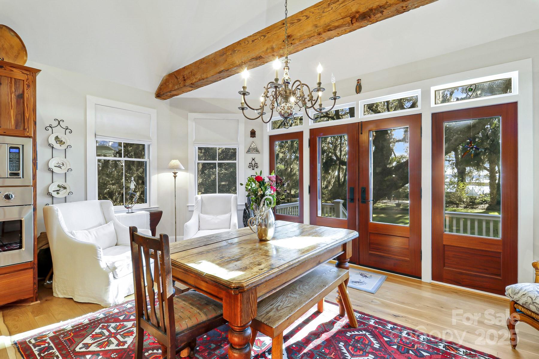 131 Pritchard Street Bluffton, SC 29910 - Photo 15 of 47 a view of a dining room with furniture wooden floor and a chandelier