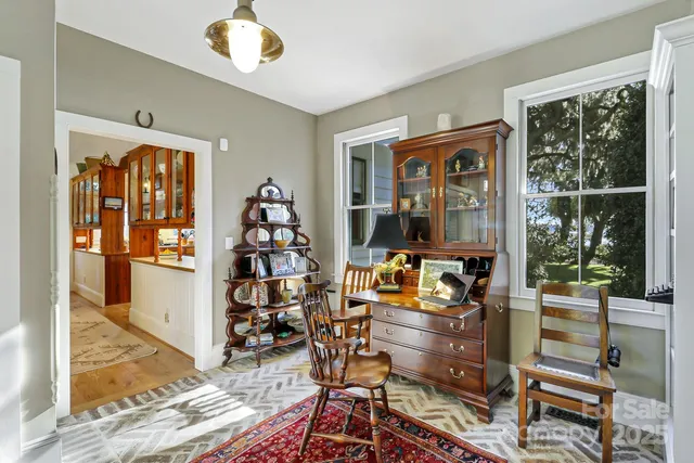 a living room with furniture a window and a flat screen tv