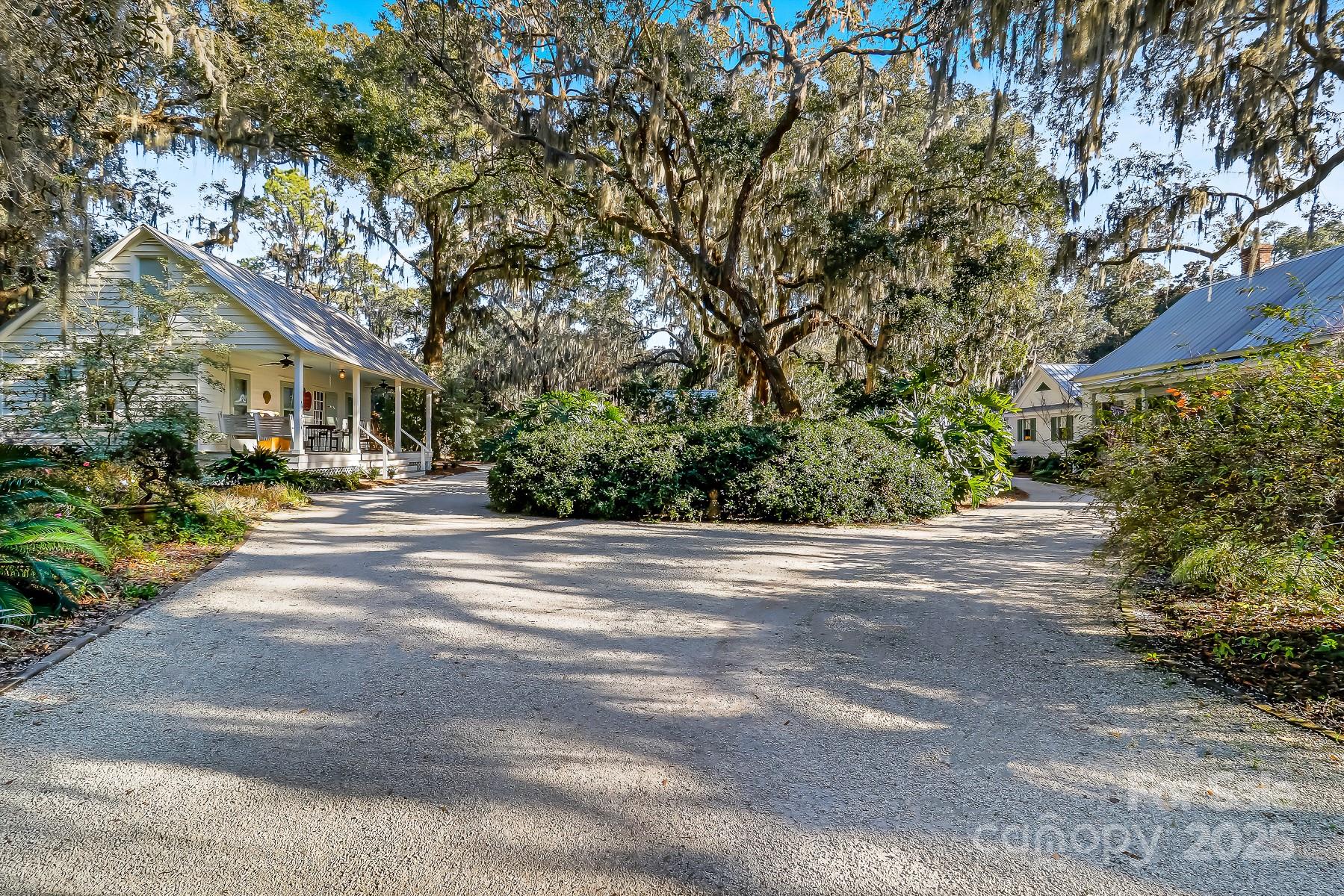 131 Pritchard Street Bluffton, SC 29910 - Photo 33 of 47 a front view of a house with a yard and potted plants