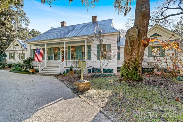 a view of a house with backyard porch and sitting area