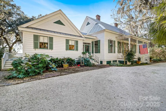 a front view of house with yard and trees around
