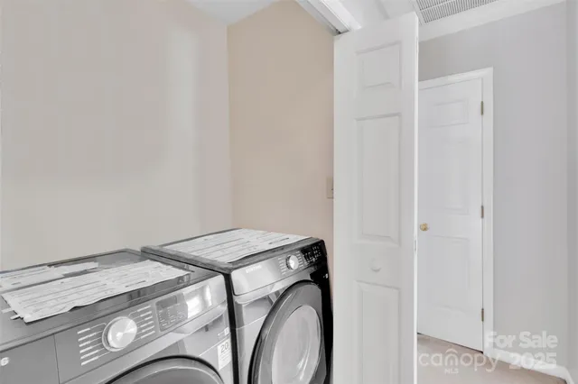 a white bed sitting in a bedroom next to a window