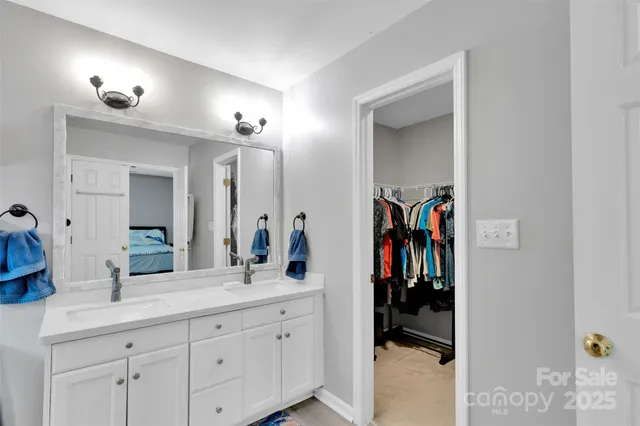 a spacious bathroom with a double vanity sink and a mirror