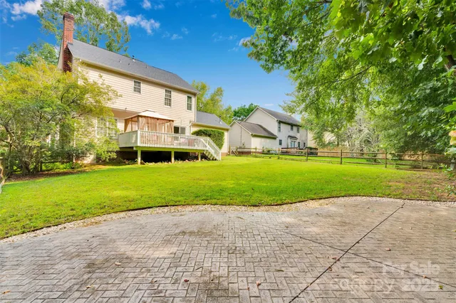 an aerial view of a house with garden space and a patio