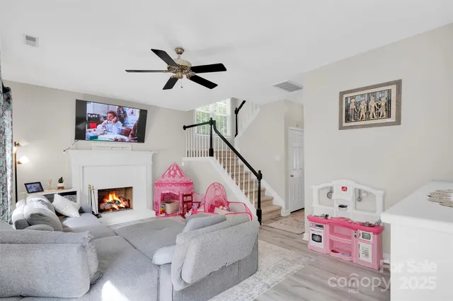 a living room with furniture or stairs and a window