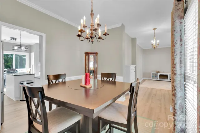 a view of a bedroom with furniture and wooden floor