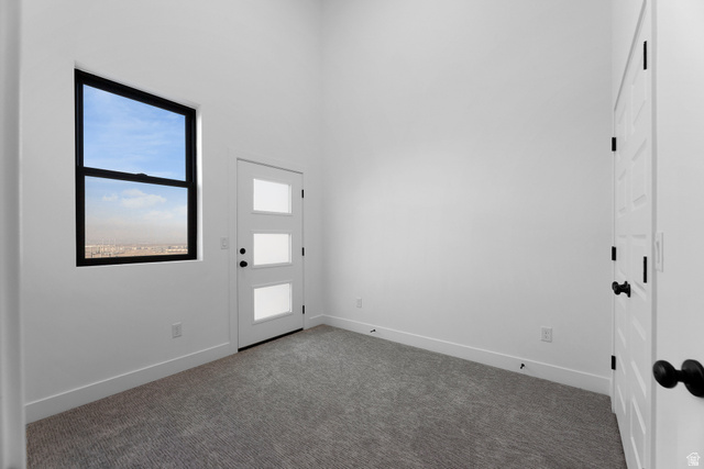 14392 South Champ Cove Draper, UT 84020 - Photo 25 of 31 Carpeted foyer entrance featuring baseboards and a high ceiling