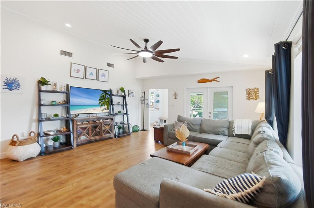 1286 Venetian Way Naples, FL 34110 - Photo 2 of 46 a living room with furniture a ceiling fan and a rug