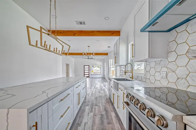 a kitchen with stainless steel appliances granite countertop a sink and cabinets