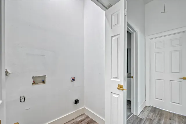 a view of an entryway with wooden floor