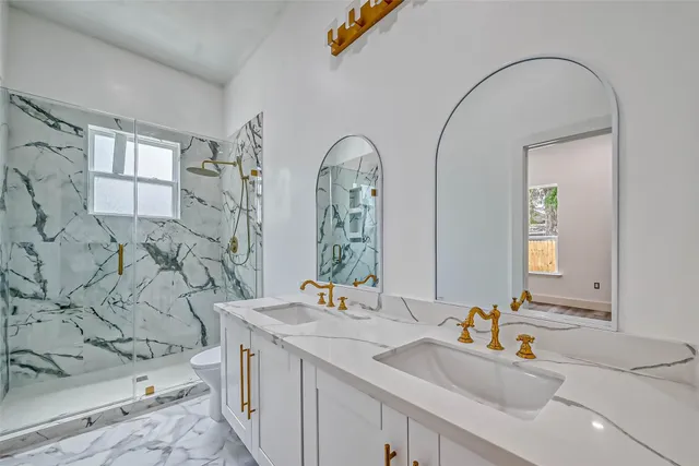 a bathroom with a sink double vanity and a mirror