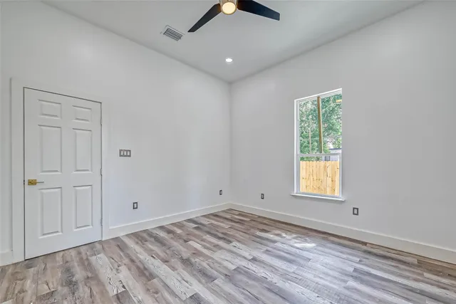 an empty room with windows and closet