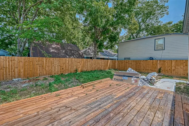 a view of a backyard with wooden fence