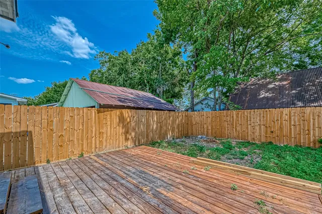 a view of a house with a wooden deck