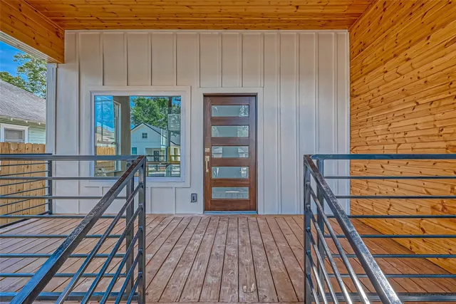 a view of a balcony with wooden floor and outdoor space