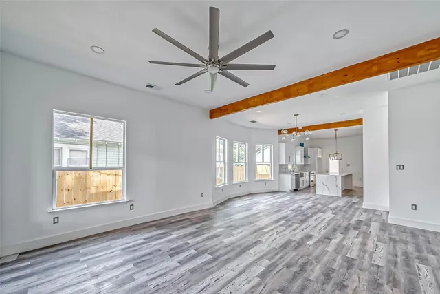 a view of a livingroom with a ceiling fan and window