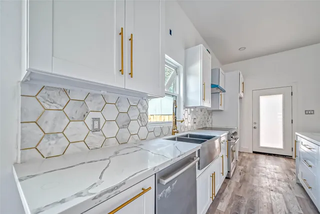 a kitchen that has a sink and a stove