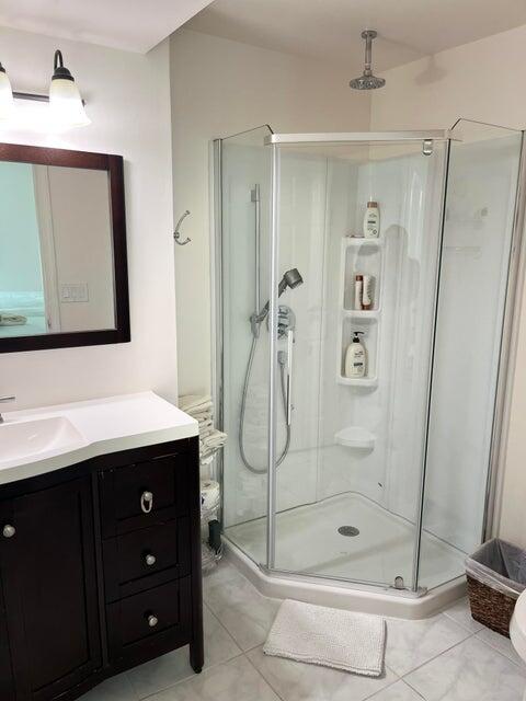 311 Pine Ridge Circle, Unit B1 Greenacres, FL 33463 - Photo 3 of 7 a bathroom with a shower a mirror and a sink