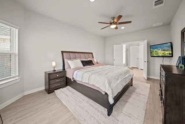 a bedroom with a bed and a chandelier