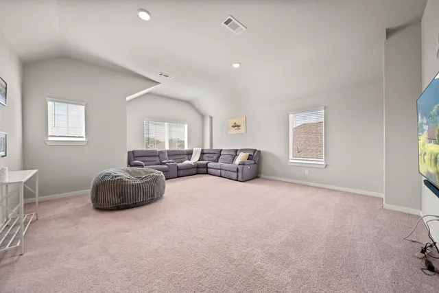 a view of a bedroom with furniture and window
