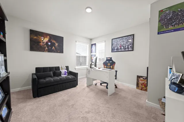 a living room with furniture and a book shelf
