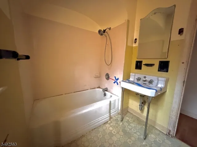 a bathroom with a bathtub and shower