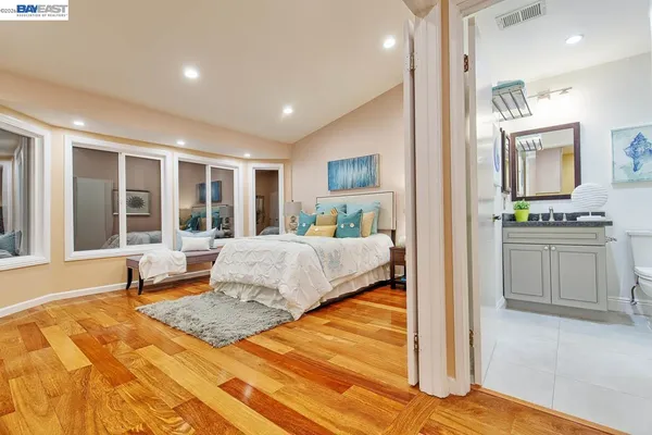 a bathroom with a granite countertop toilet sink and mirror