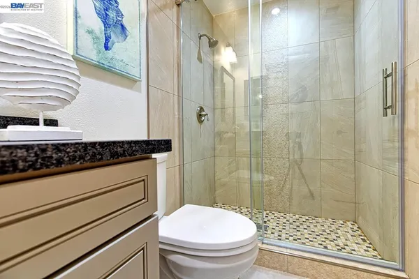 a view of a patio with table and chairs with wooden floor and fence