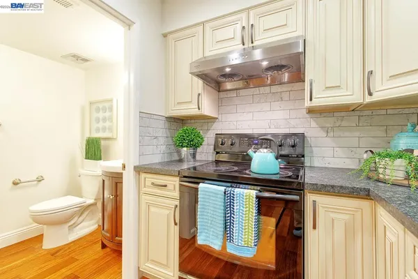 a kitchen with stainless steel appliances granite countertop a stove and a sink
