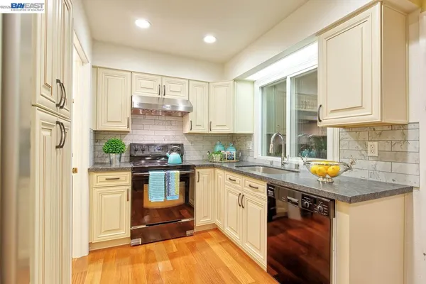 a kitchen with stainless steel appliances a refrigerator and a stove top oven