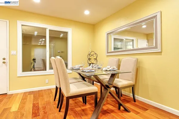 a view of a dining room with furniture and wooden floor