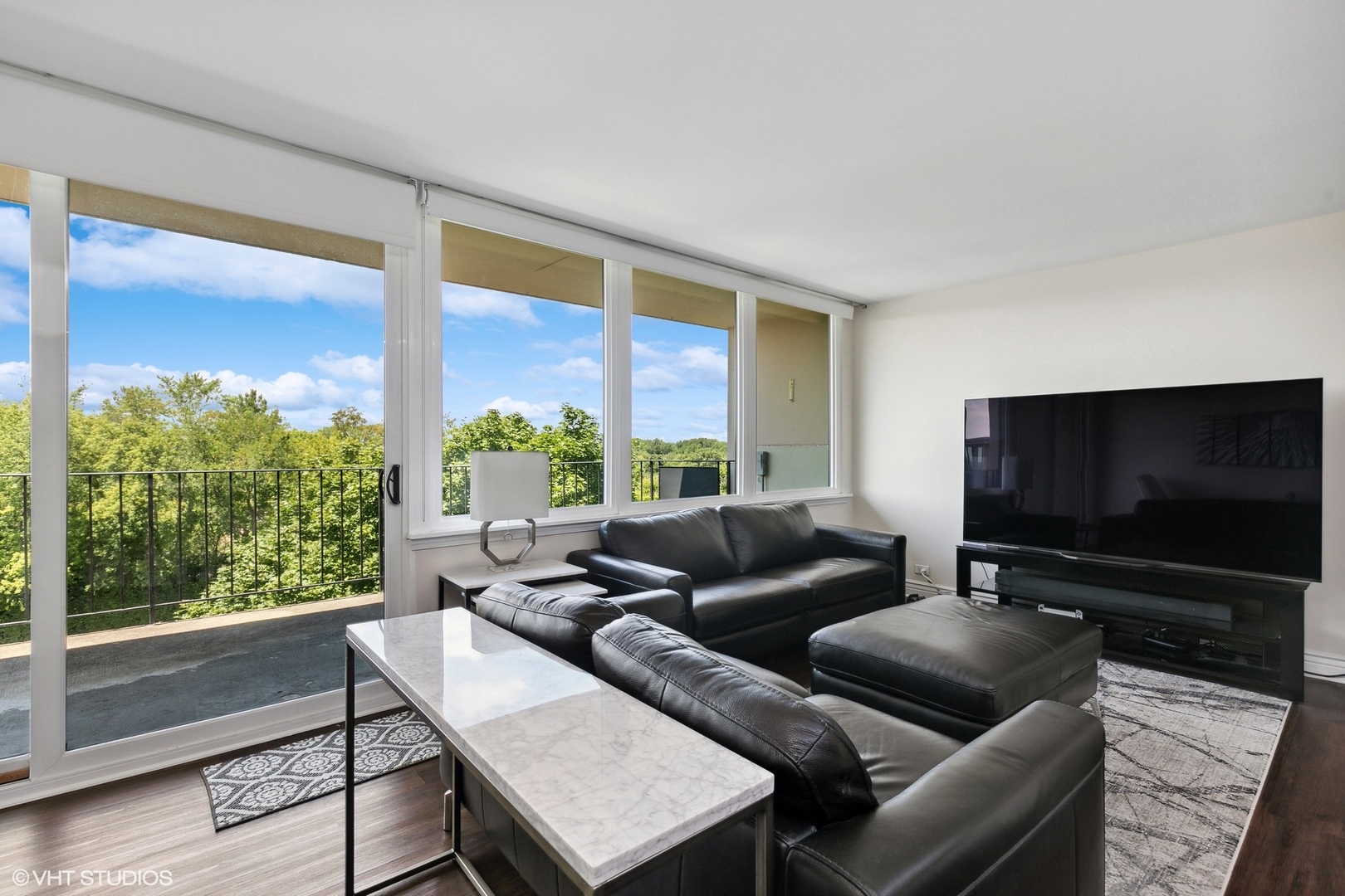 101 Bar Harbour Road, Unit 6E Schaumburg, IL 60193 - Photo 13 of 23 a living room with furniture and a flat screen tv