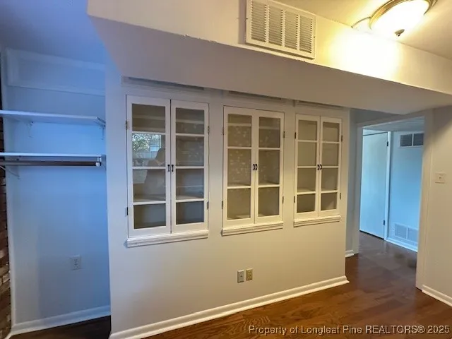 a view of backyard with wooden fence and large trees