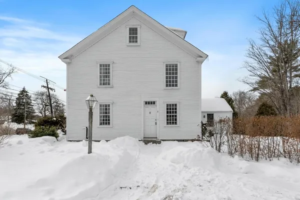 a view of a house with a snow in the yard