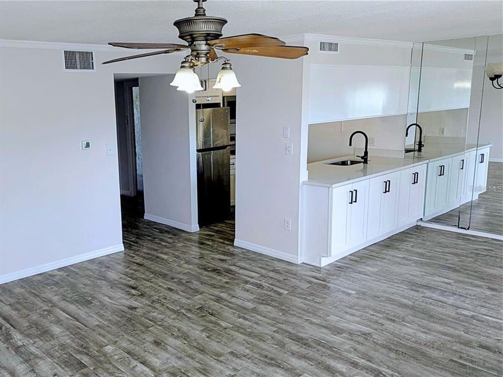 5434 Chad Place, Unit 14 New Port Richey, FL 34652 - Photo 4 of 13 a kitchen with stainless steel appliances granite countertop a sink and a refrigerator